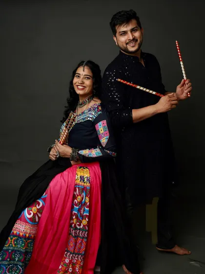 A fun and festive couple's portrait for Navratri. The energy and color of their traditional Garba outfits shine in this studio shot.