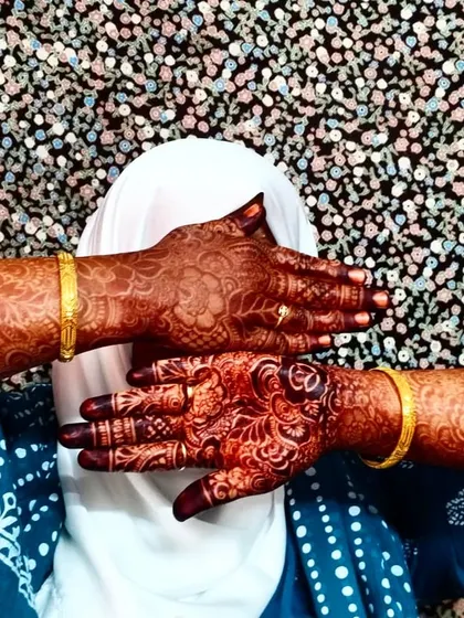 A playful pose that still shows off the incredible dark stain of the bridal mehndi.