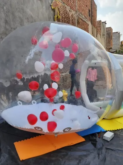 This angle shows the attached inflatable entry tunnel, which keeps the main dome inflated while people go in and out. The entire structure is made from durable, high quality transparent material.