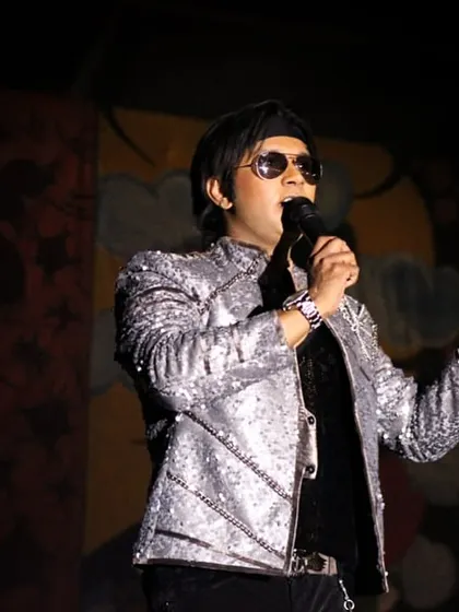 Rocking the silver sequin jacket at a college show. These early performances were crucial in shaping the artist I am today.