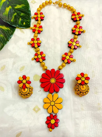 A bright red and yellow version of the three-layer floral necklace, ideal for haldi ceremonies or as a pop of color.