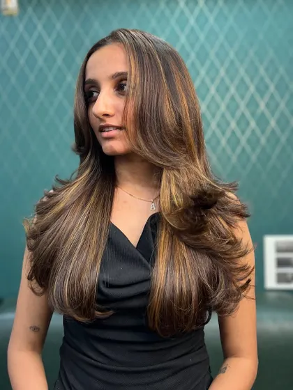 A different angle of our popular caramel balayage. The placement of the highlights is designed to contour the face and add dimension exactly where it's needed.