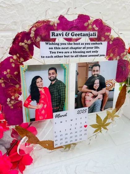 The same frame without the LED lights on, showing the vibrant red of the preserved flowers and the personalized message.