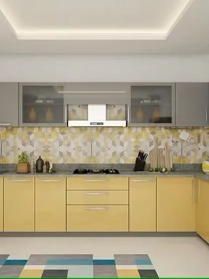 This two-tone L-shaped kitchen pairs soft yellow base cabinets with neutral grey uppers. The patterned tile backsplash adds a decorative touch, tying the color scheme together for a cohesive and stylish look.