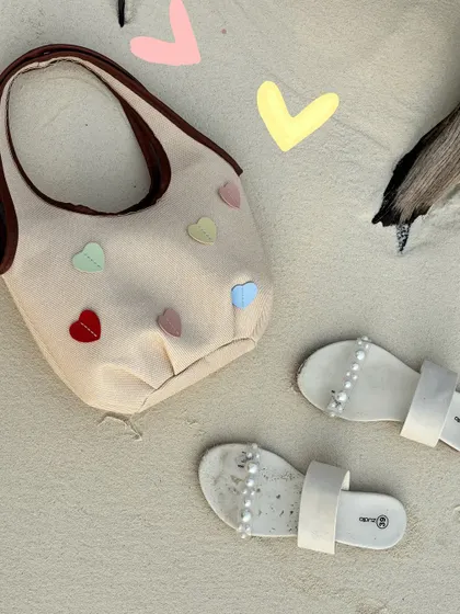 A flatlay of my beach essentials, with some cute heart doodles to add a pop of color.