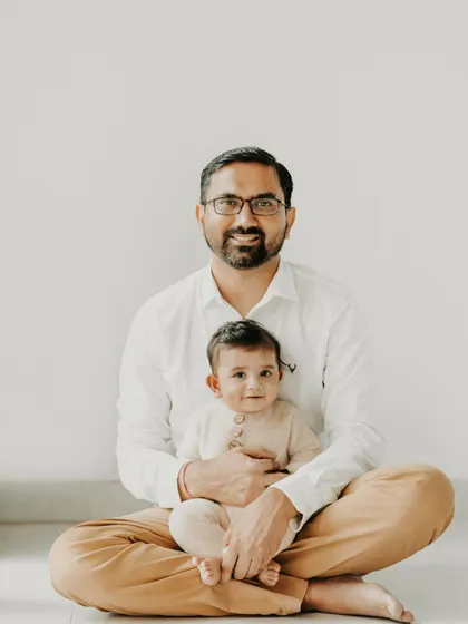 This full-length portrait of a father and his baby shows their comfortable, easy connection. We took our time during this family session, allowing for natural poses that feel authentic and relaxed, which is especially important when working with little ones.