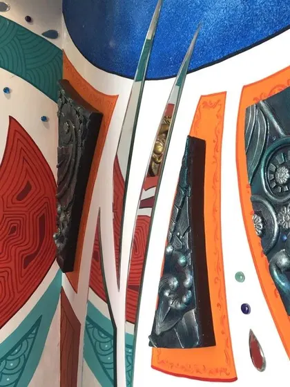 A close-up of the mixed-media mural, showing the hand-painted abstract shapes alongside custom-made 3D fiber art pieces. This technique adds physical depth and texture to the wall.