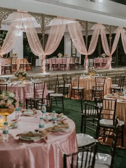 For this garden reception, we created a romantic dining experience inside a beautiful gazebo. The soft pink drapes and lush greenery created an intimate and elegant setting for the couple's celebration.
