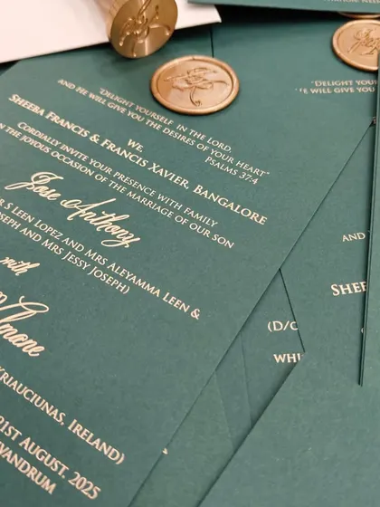 A detailed shot of the Glassglow Green invitation, showing the crisp white typography and the rich texture of the premium paper.