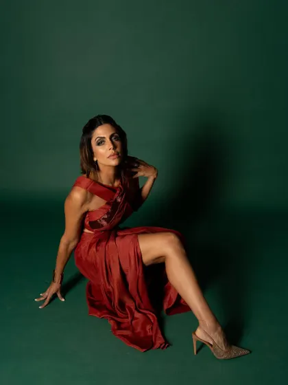 This wider seated shot for iDiva provides more context of the pose and the flow of the dress, creating an elegant and strong composition.