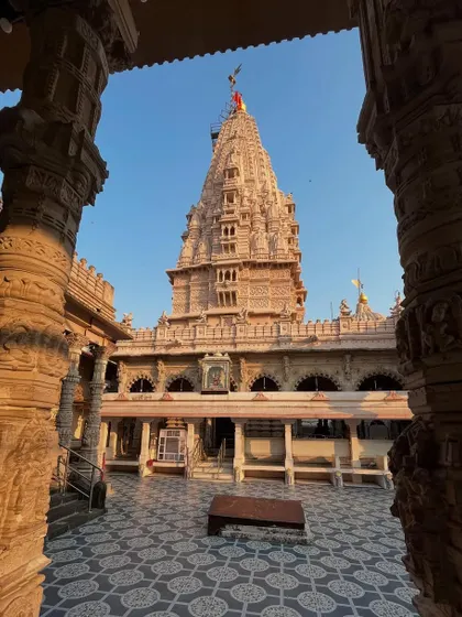 A view of the Babulnath Temple's main shikhara, framed by two pillars, showcasing the ancient Shiva temple's architecture.