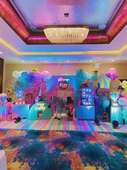 Another angle of the colorful carnival stage, showing the full setup with a zebra, elephant, and ferris wheel.