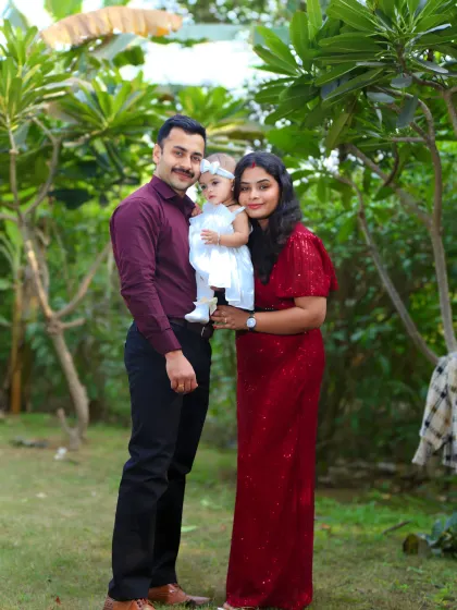 A beautiful family portrait taken during an outdoor first birthday celebration.