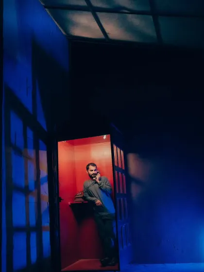A stylized shot of me in a phone booth, lit with dramatic blue and red light. This shows my experimentation with color and shadow to create a cinematic mood.
