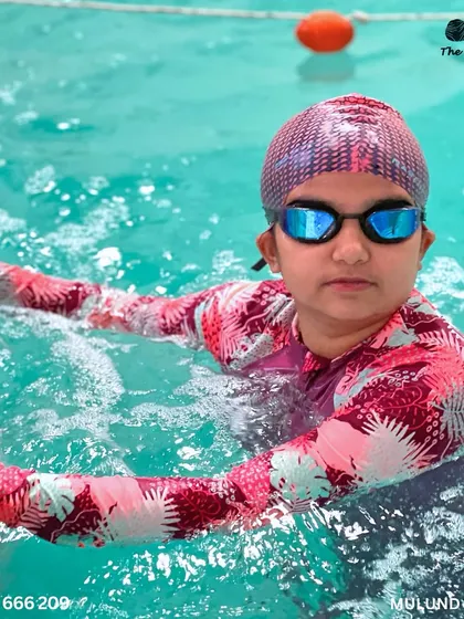 Little swimmers, big adventures. A participant takes a moment to rest between her races at the gala.