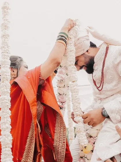 A fun moment from the Varmala ceremony, with the groom lifted on his friends' shoulders.