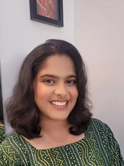 Another angle of the soft makeup look with a hint of green on the eyes. The natural light shows off the radiant skin finish.