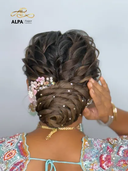 Another angle of the elegant bun, showing how the handmade accessory is placed to enhance the hairstyle.