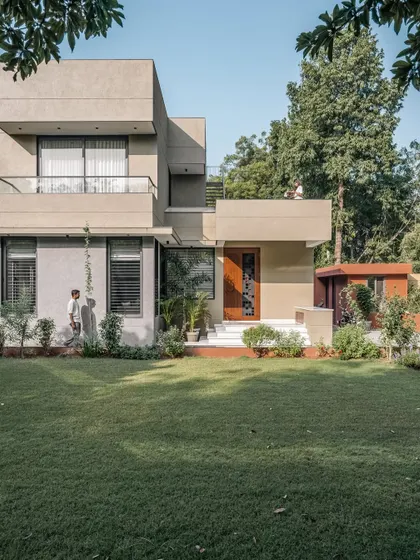 **The Glow House, Ahmedabad:** The architectural composition uses interlocking volumes to create terraces and shaded areas. This approach breaks down the scale of the building, making it feel more approachable while providing private outdoor spaces for the family.