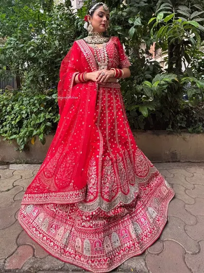 A classic red bridal lehenga with beautiful embroidery. This is a timeless piece that you can rent for your special day.