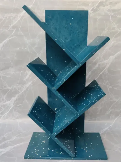 A clean shot of our blue marble bookshelf, highlighting the unique speckled pattern. This piece combines modern design with a powerful environmental message.