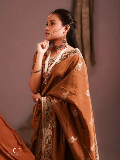 A classic three-quarter pose that showcases the beautiful drape of the saree. Her expression is serene and timeless.