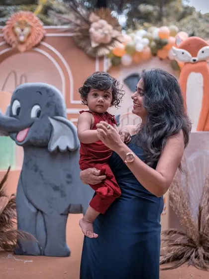 A sweet photo of the birthday boy and his mom in front of the adorable elephant prop. The decor is designed to create beautiful backdrops for family portraits.