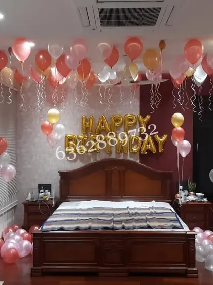 A classic surprise birthday decoration, filling the bedroom with helium balloons floating on the ceiling.