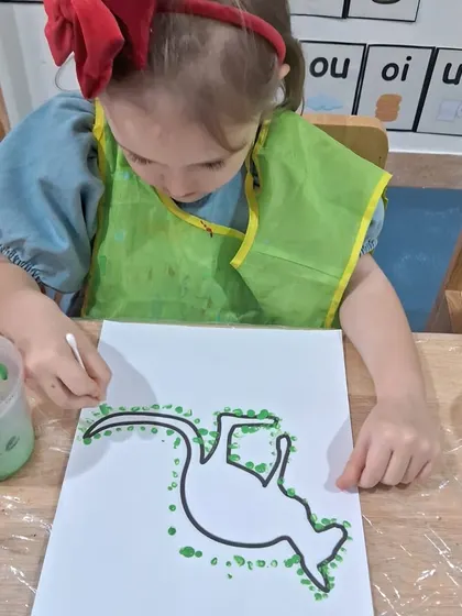 This young artist is focused on creating her dot painting. This technique is excellent for developing fine motor control and patience while learning about Australian culture.