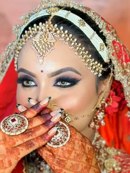This is the magic of a classic bridal look. Here, I focused on creating a dramatic winged eyeliner and bold smokey eye that makes the bride's eyes pop, a technique I teach all my students for creating unforgettable wedding day makeup.