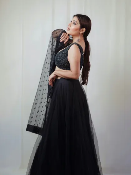 A full-length shot of the black lehenga, showcasing its beautiful flow and silhouette. The pose is elegant and statuesque, perfect for a fashion lookbook.