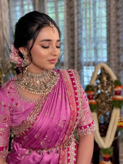 A moment of quiet reflection. The makeup is soft and romantic, with a focus on the eyes and a flawless complexion.