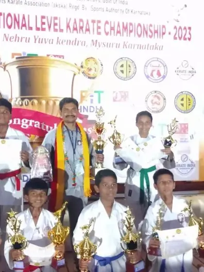 Celebrating with my students on stage at the 6th GKA Open National Karate Championship in Mysore after a very successful tournament.