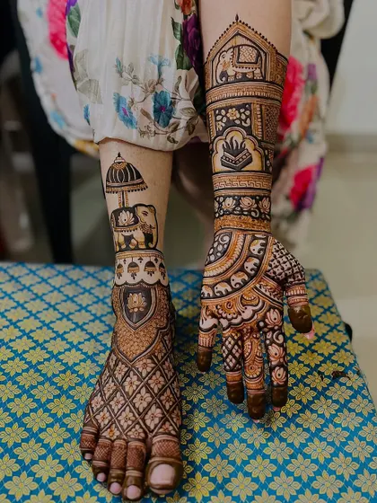 This design shows how hand and foot mehndi can tell a story together. The foot features an elephant with a royal umbrella, which complements the traditional motifs on the hand.