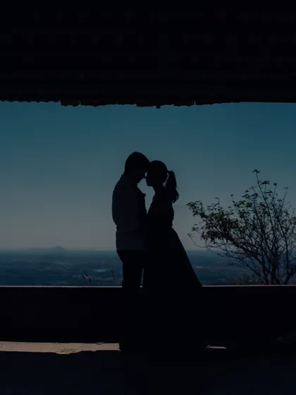 Using the architecture to frame this silhouette shot adds depth and a sense of place to the couple's intimate moment.