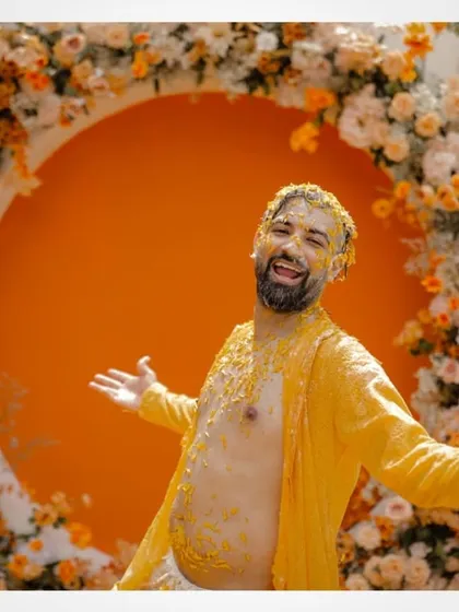 The groom covered in haldi, a classic and joyful shot from the ceremony.