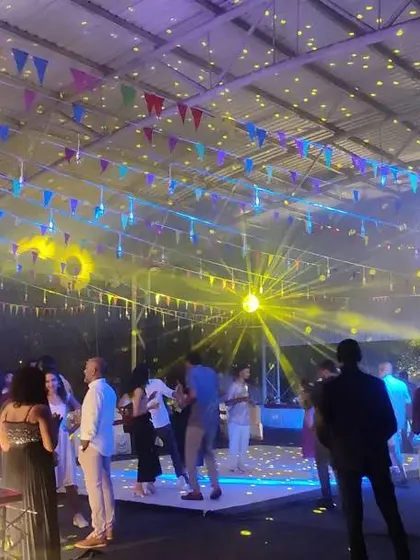 A wide shot of the party in full swing, showing the dynamic lighting and energetic atmosphere we can create for your corporate event.