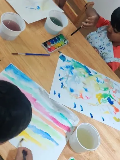 A closer look at our watercolor session. We provide quality materials and guidance, but the real learning happens when children experiment with the water and pigments to see what they can create.