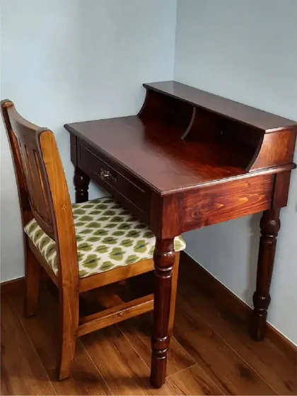 A custom-made work table with turned legs and a matching chair with an upholstered seat, showcasing traditional woodworking techniques.