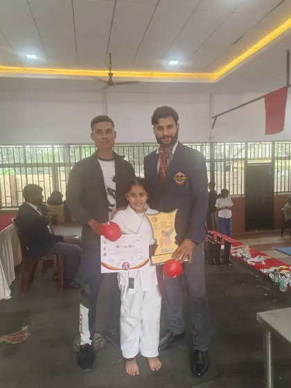 A student and her coaches celebrate a tournament victory. We are a team that supports each other through every challenge and success.