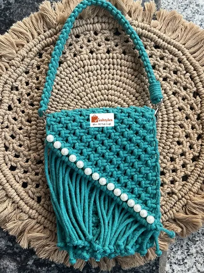 Another look at this gorgeous teal handbag with pearl embellishments. It's a perfect example of how a little detail can elevate a design.