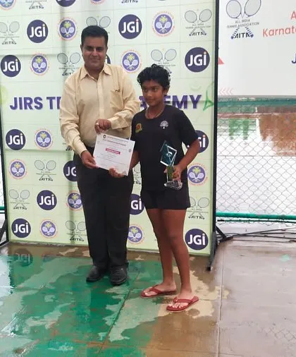 Eshita receiving her doubles winner certificate at the AITA CS 7 Under 14 tournament in Bangalore.