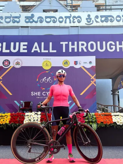Standing proud with my bike at the Women's Day cycling event.