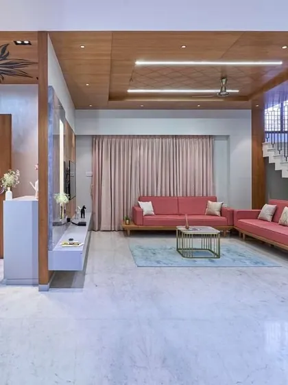 Another view of this expansive living room, showing how the different seating areas are arranged to create both a large gathering space and more intimate zones. The wood ceiling ties the entire room together.