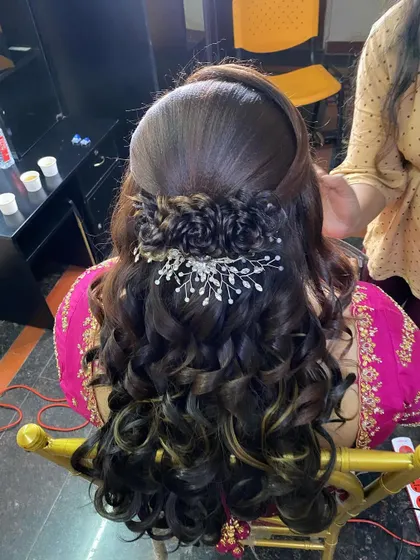Another angle of the reception hairstyle, showing the intricate braided detail and the sparkling accessory placed above the curls.