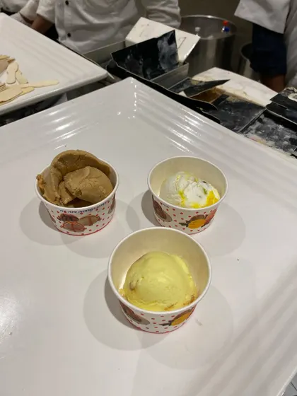 Small cups of assorted ice cream flavors, a simple and refreshing dessert option.