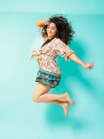 A joyful jump against a bright blue background. This type of photo is excellent for commercial work that requires an energetic and youthful feel.