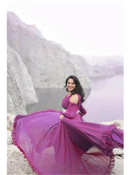 A joyful, twirling shot in the wine-blue gown, showing off its beautiful drape and unique color.