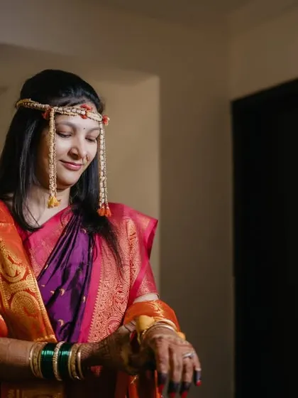 A candid shot of the bride checking the time, a small, human moment amidst the grandeur of the wedding day.
