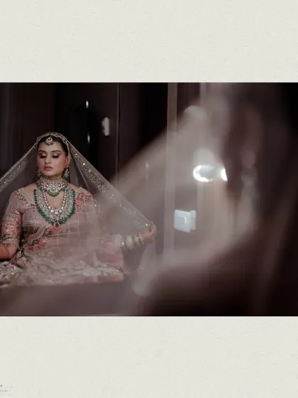 The bride's reflection in a mirror, capturing a quiet moment of contemplation.